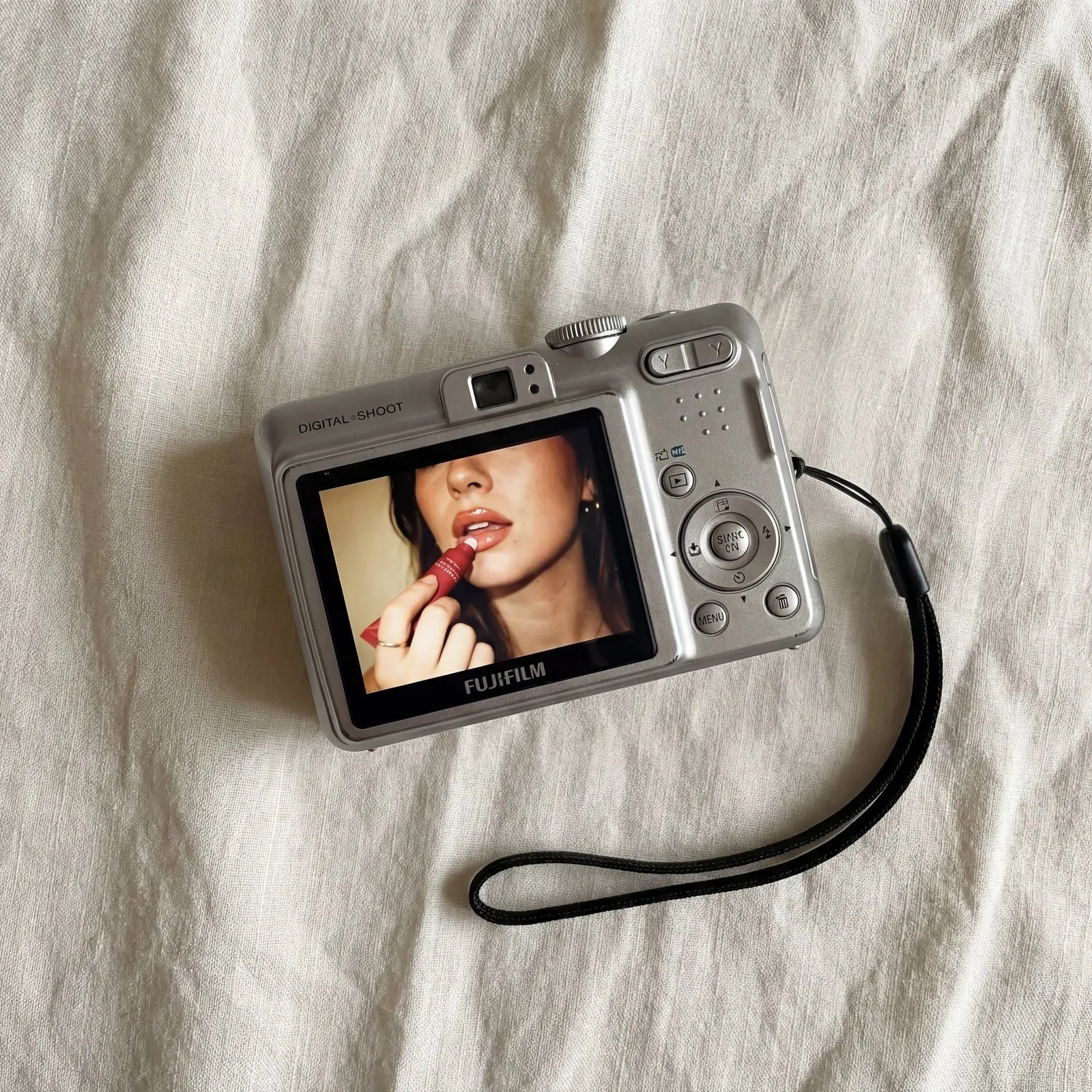 Digital camera lip balm flat lay image