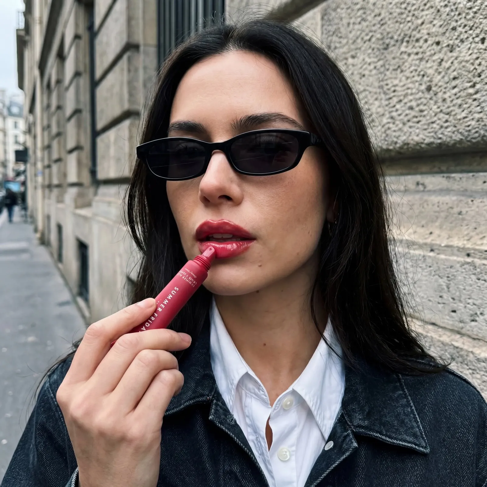Street-style lip balm application image