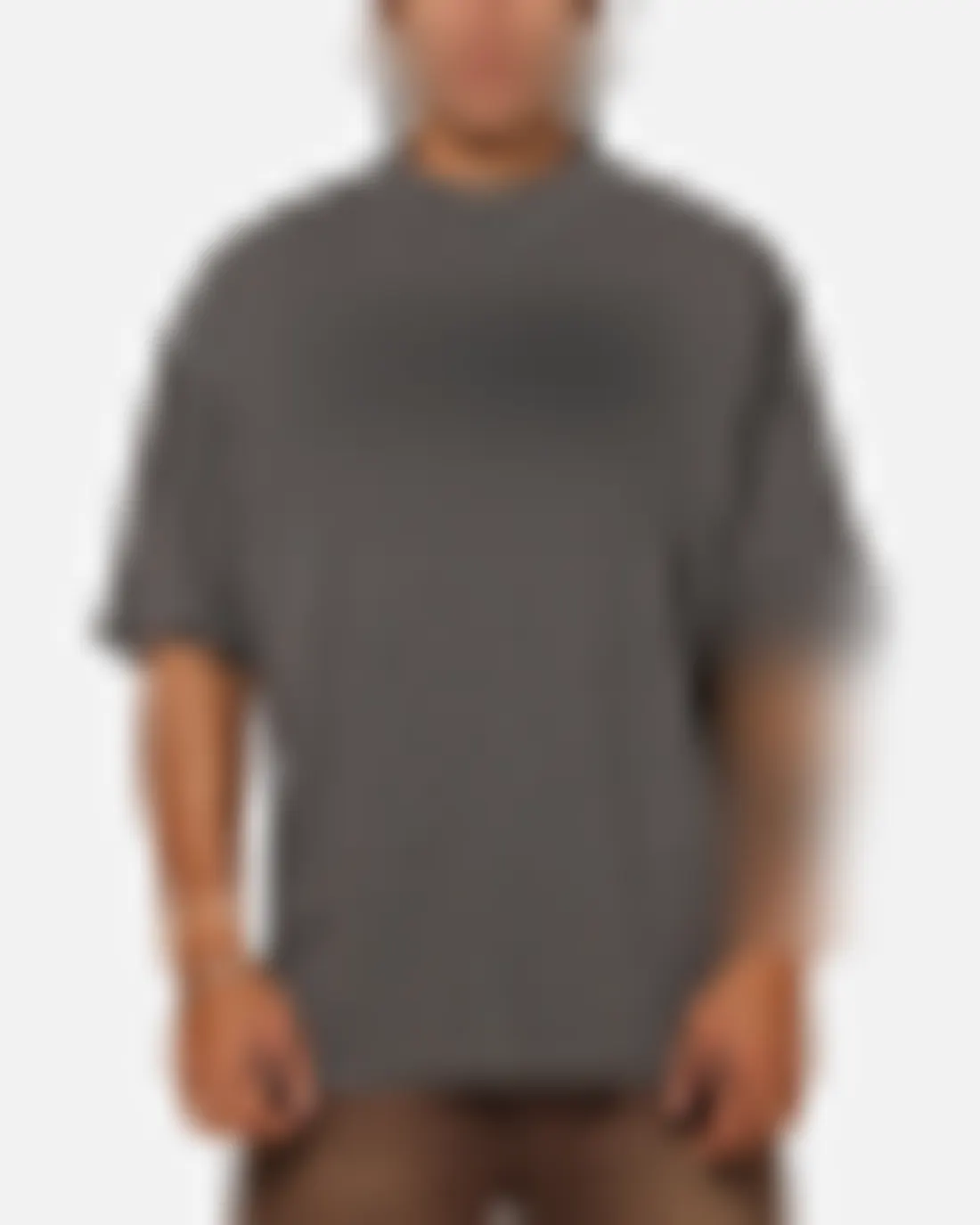Existing product image of a house-brand tee on a model, blurred to protect the client
